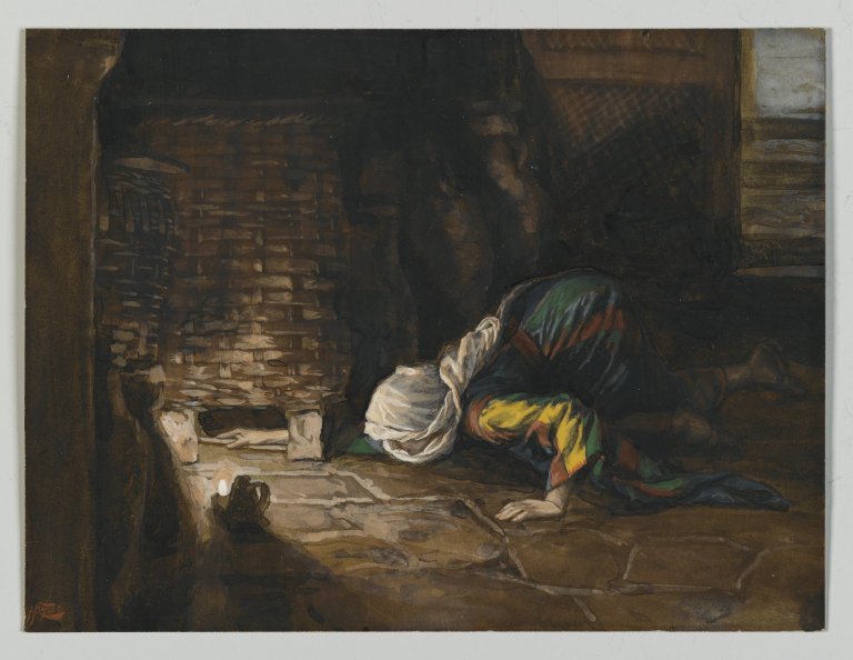 A woman kneels on the floor, searching intently for a lost coin under a woven basket, illuminated by a small candlelight, showcasing a moment of diligence and focus.